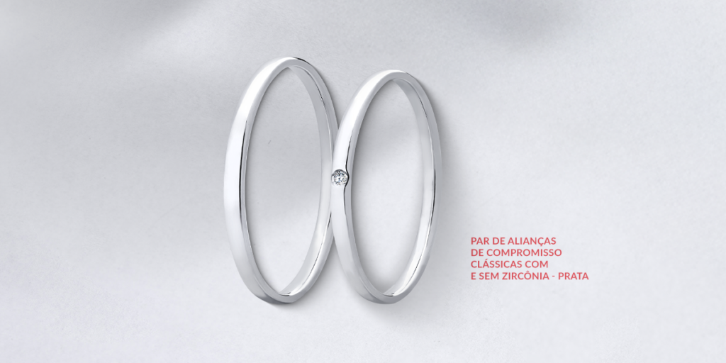 duas alianças finas e uma com ponto de luz